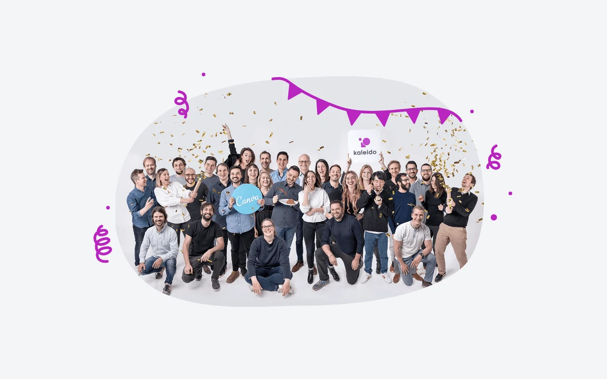 Kaleido team celebrating in front of a Canva sign after the 2021 acquisition