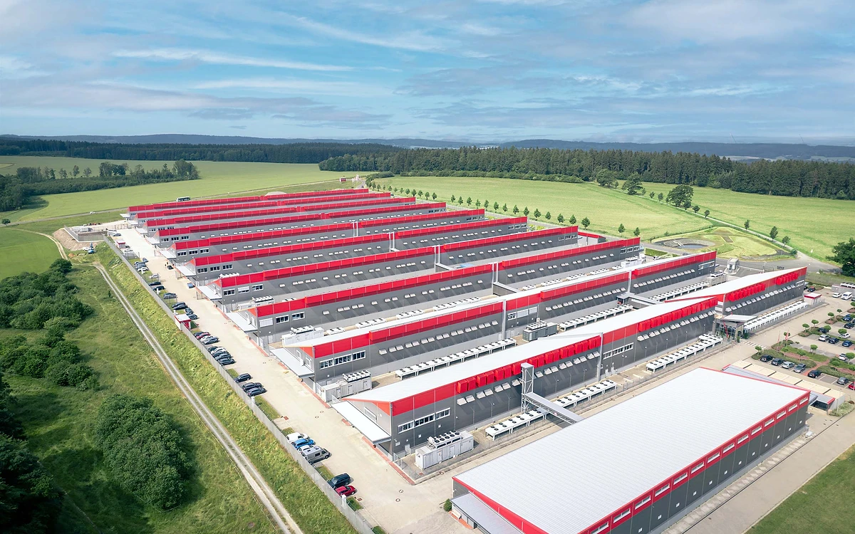 Aerial photo of Hetzner's Falkenstein data center park with rows of low data center buildings surrounded by fields