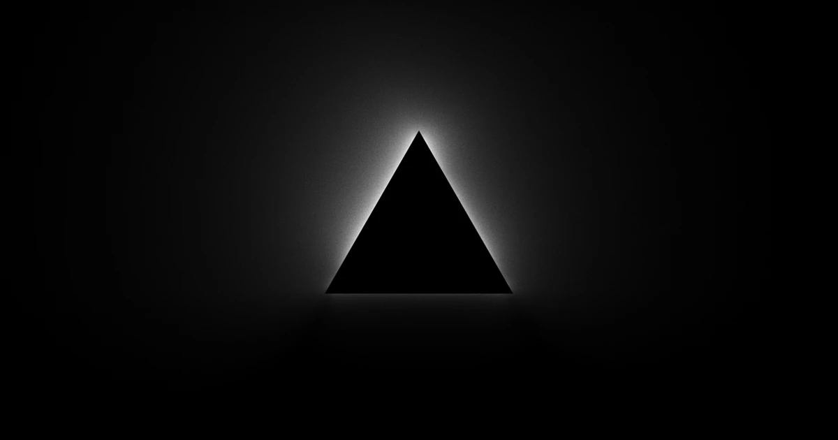 Backlit black Vercel triangle logo on a black background