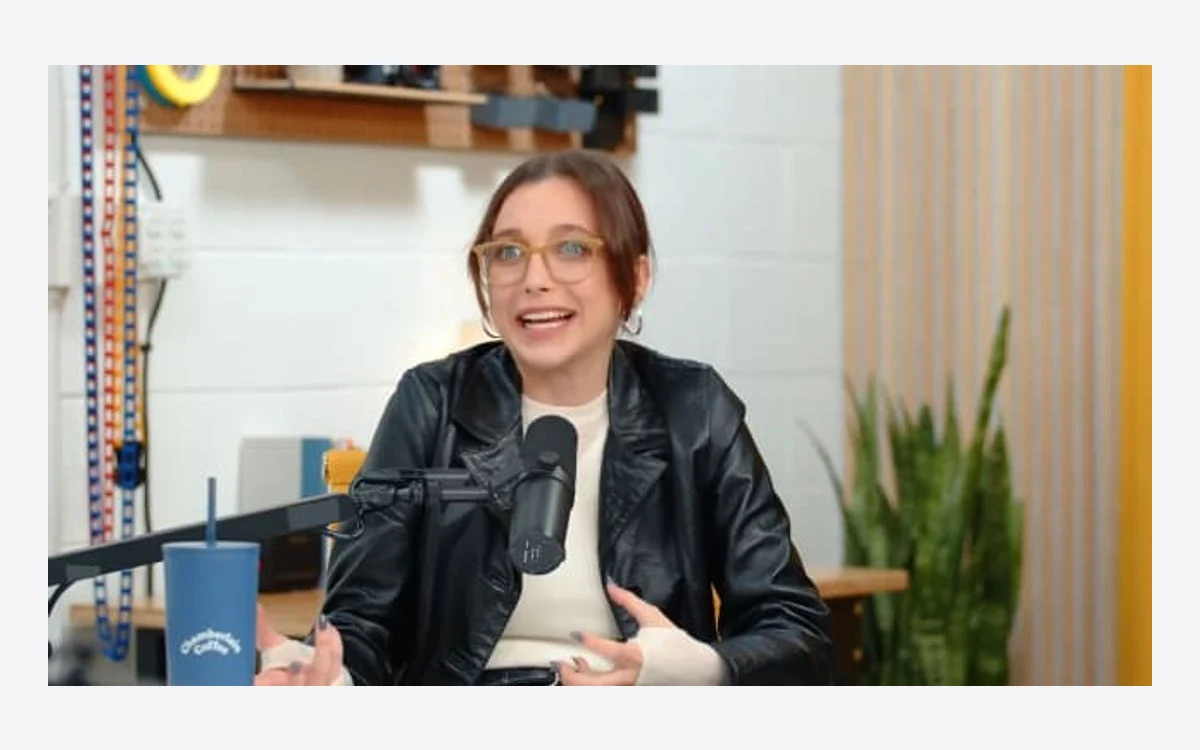 Podcast host speaking into a microphone in a wide 16:9 studio shot