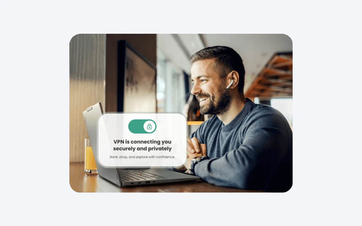 Man using a laptop in a cafe with a McAfee overlay reading VPN is connecting you securely and privately